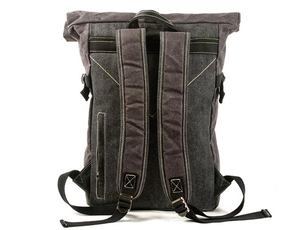 Back of a waxed canvas roll top backpack showing padded shoulder straps and a leather carry handle