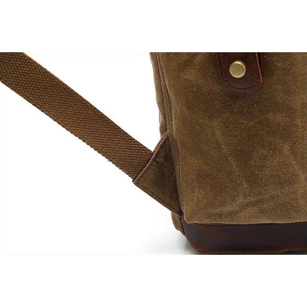 Leather base and shoulder strap anchor on the khaki rucksack