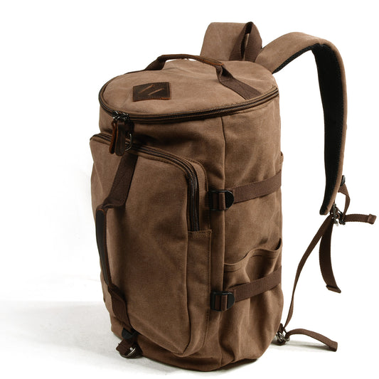 Khaki canvas backpack at an angle with side compression straps and leather zipper pulls.