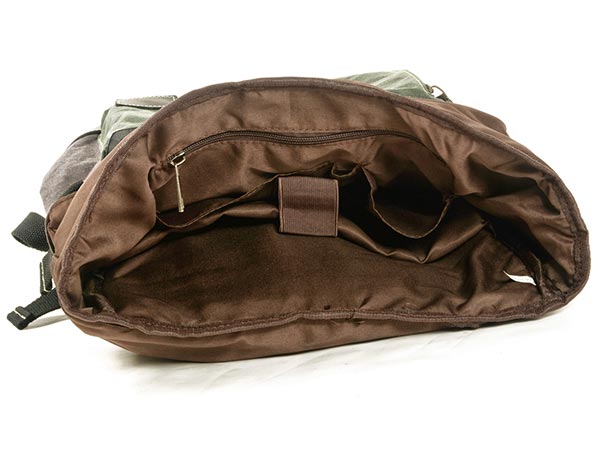Open waxed canvas backpack showing a padded laptop sleeve and inner storage pockets