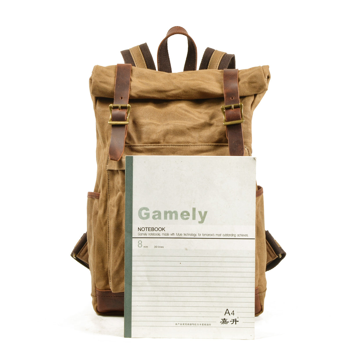 Roll top backpack beside an A4 notebook to show its size