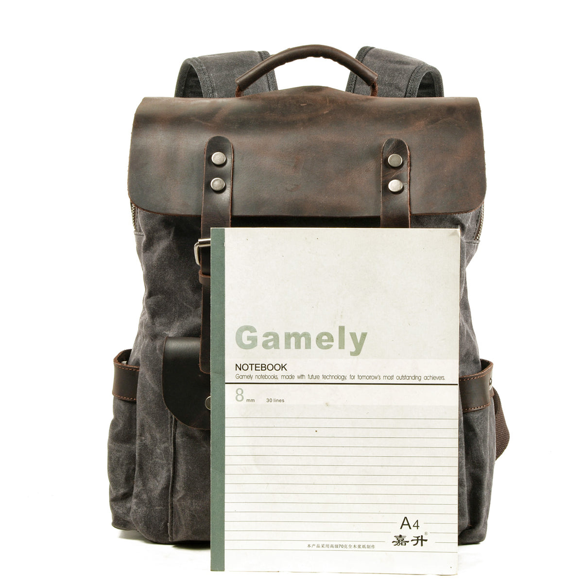 Gray backpack beside an A4 notebook to show its size