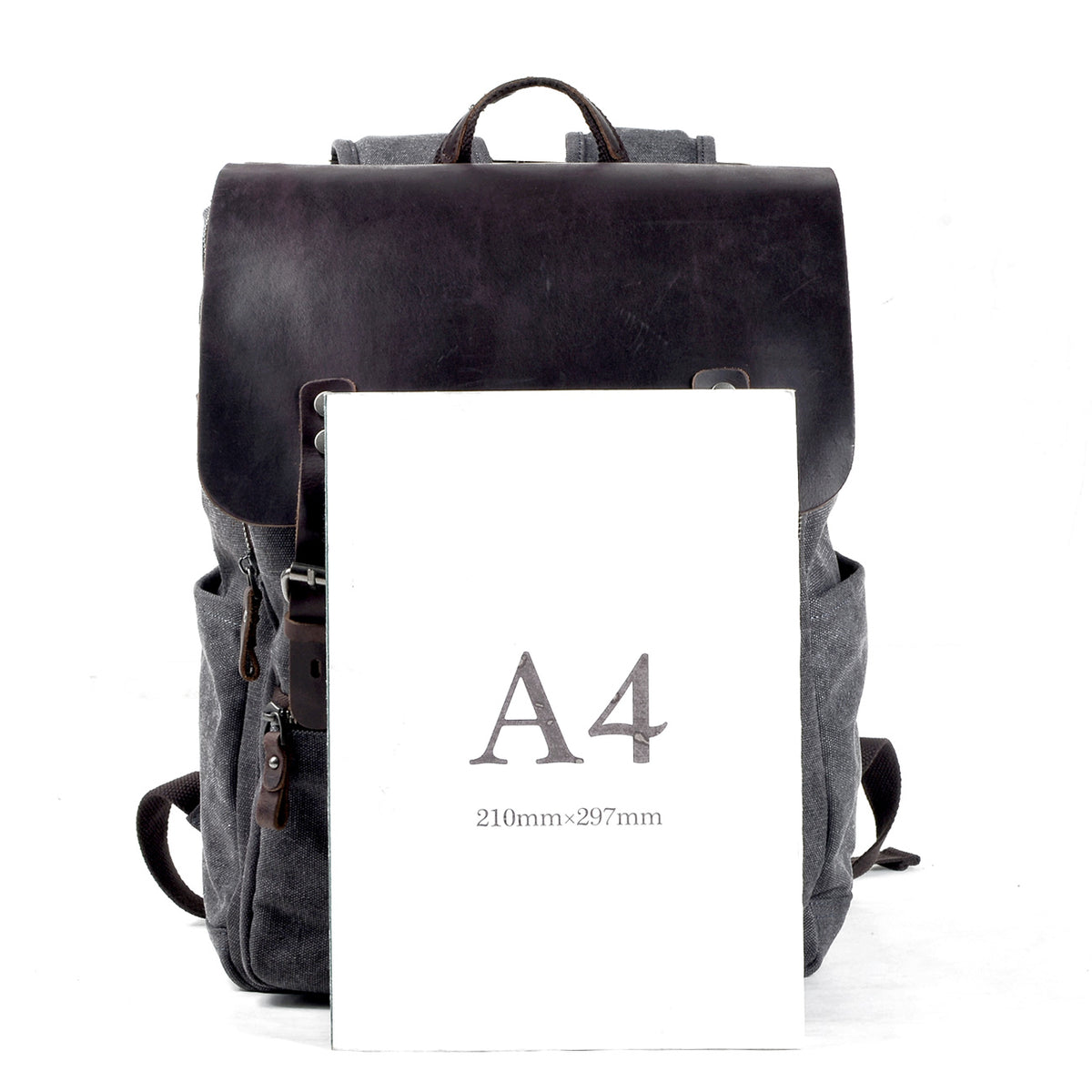 Canvas backpack beside an A4 sheet measuring 210 by 297 mm for size comparison