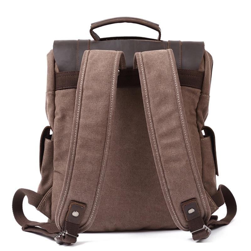 Back of coffee waxed canvas backpack with padded shoulder straps and leather-reinforced attachment points.