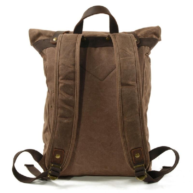 Rear of the backpack with adjustable shoulder straps, a carry handle and leather base