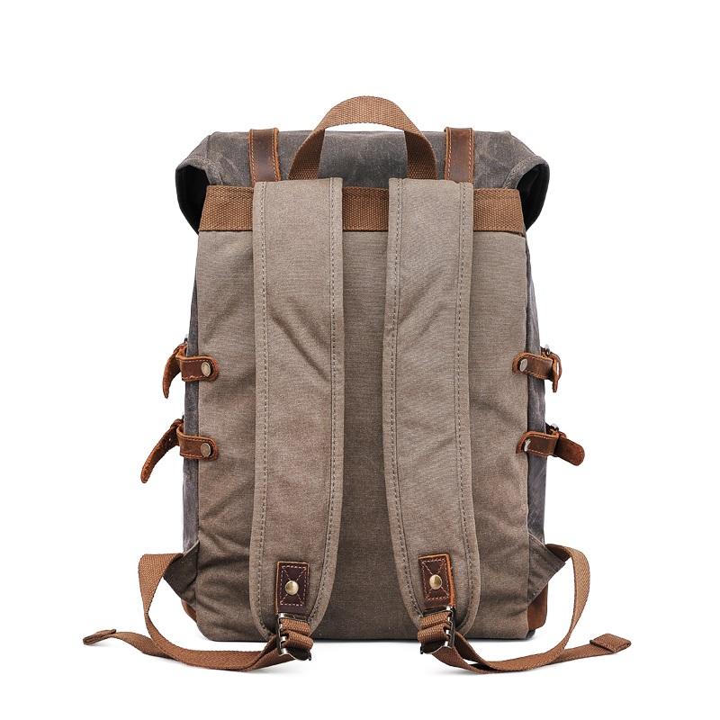 Back of the gray backpack with padded shoulder straps and leather top handle
