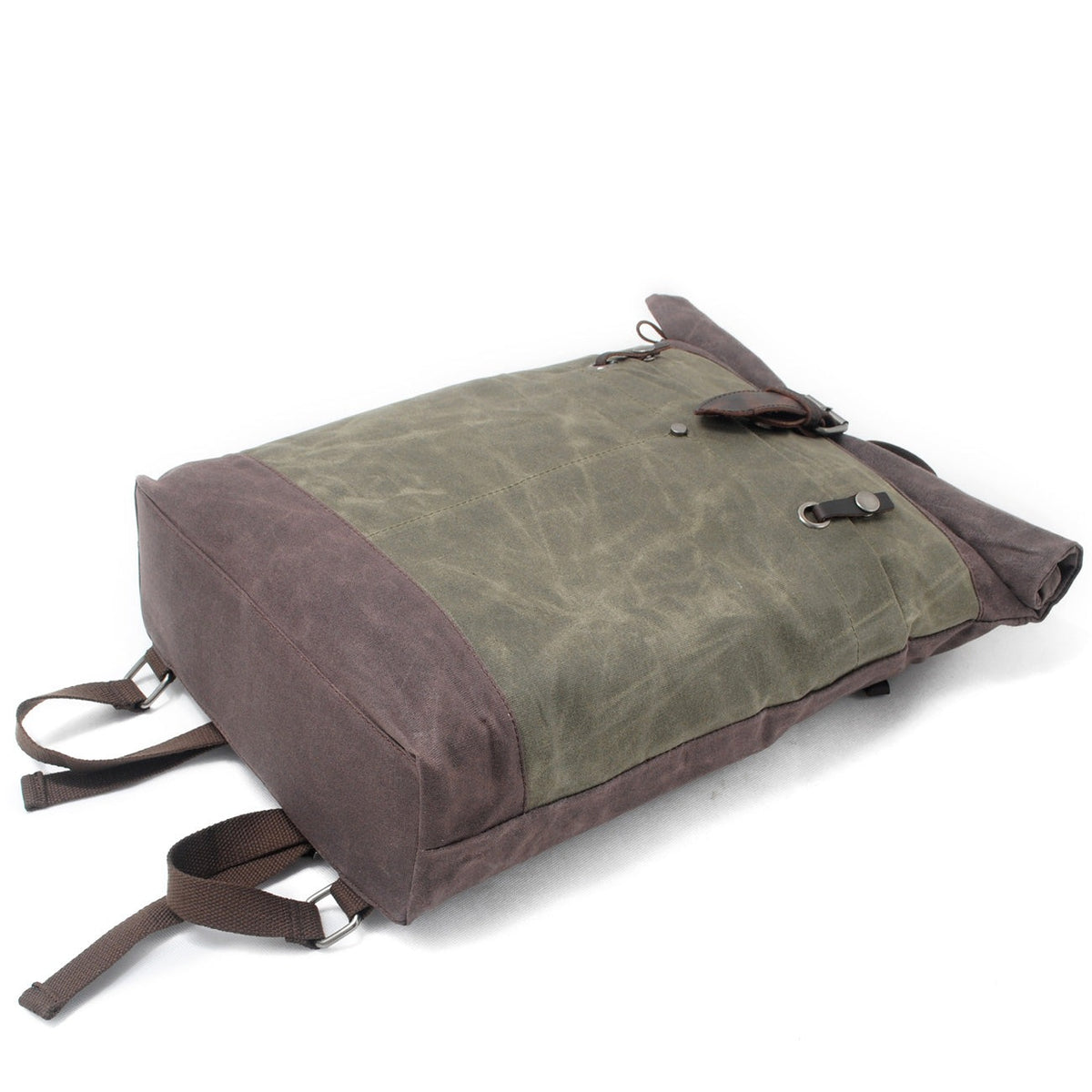 Army waxed canvas backpack lying on its front to show the brown base.