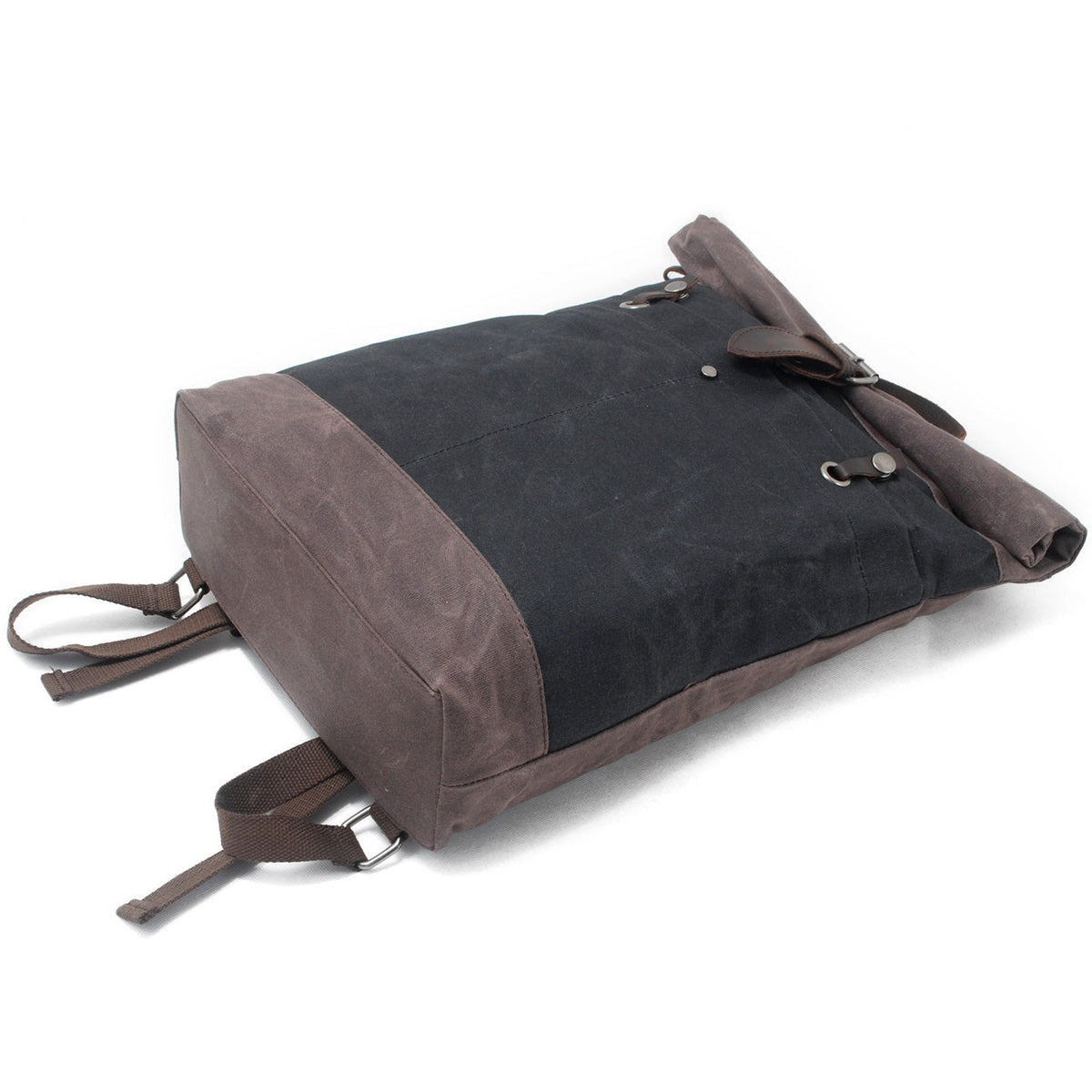 Black backpack lying on its front to show the brown base