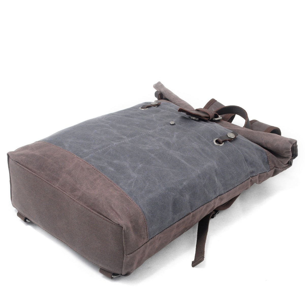 Gray backpack lying on its front to show the brown canvas base