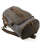 Backpack laid on its side with the zippered bottom compartment facing forward