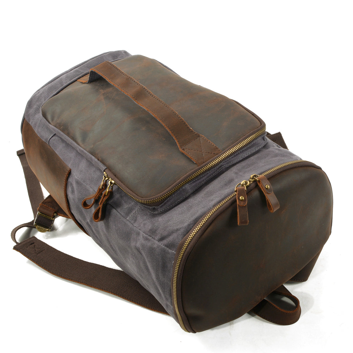 Backpack laid on its side with the zippered bottom compartment facing forward