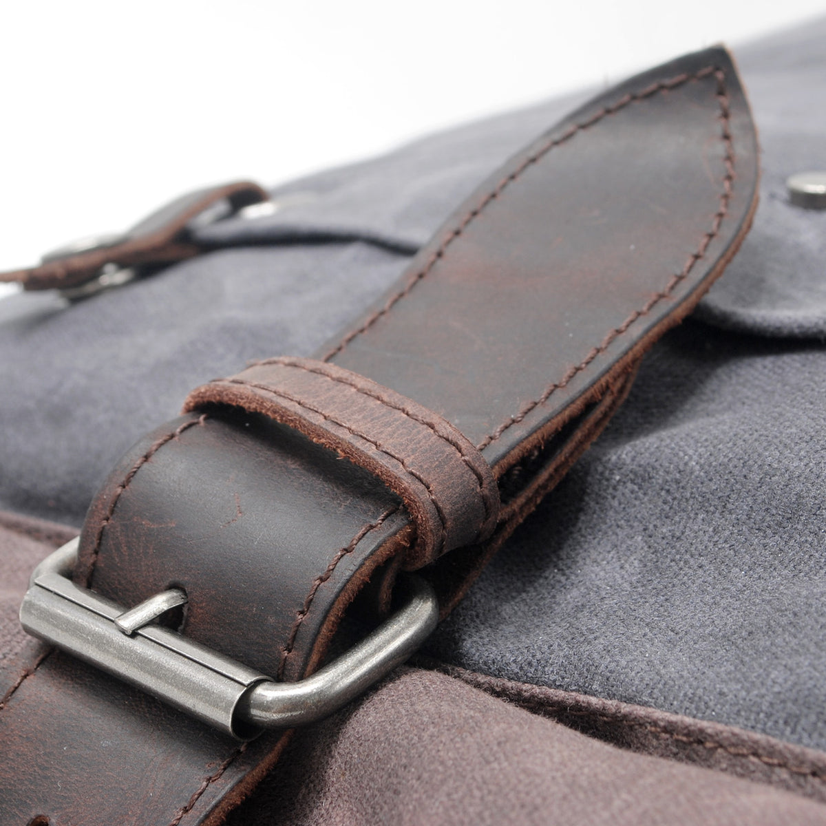 Close-up of the metal buckle on the leather closure strap
