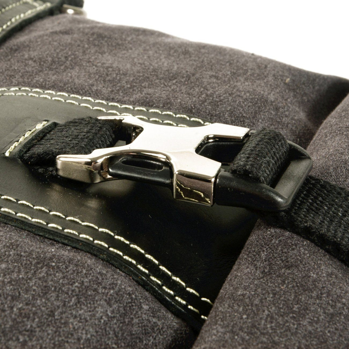 Close-up of the roll top closure's metal buckle, webbing strap and stitched leather reinforcement