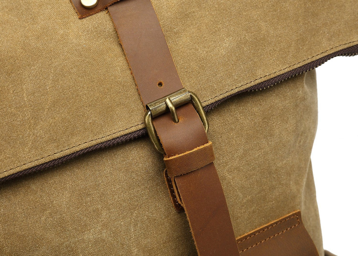 Close-up of the brass buckle on the Khaki backpack front strap.
