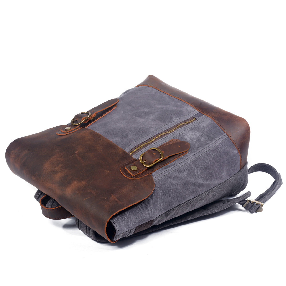 Gray backpack lying on its side with the buckled leather flap