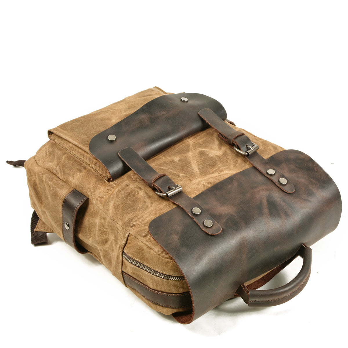Khaki backpack lying on its back with the leather flap buckled