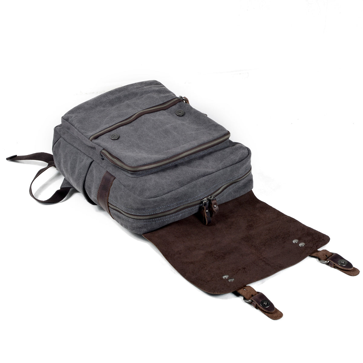 Backpack lying flat with its leather flap open and the zippered main compartment closed