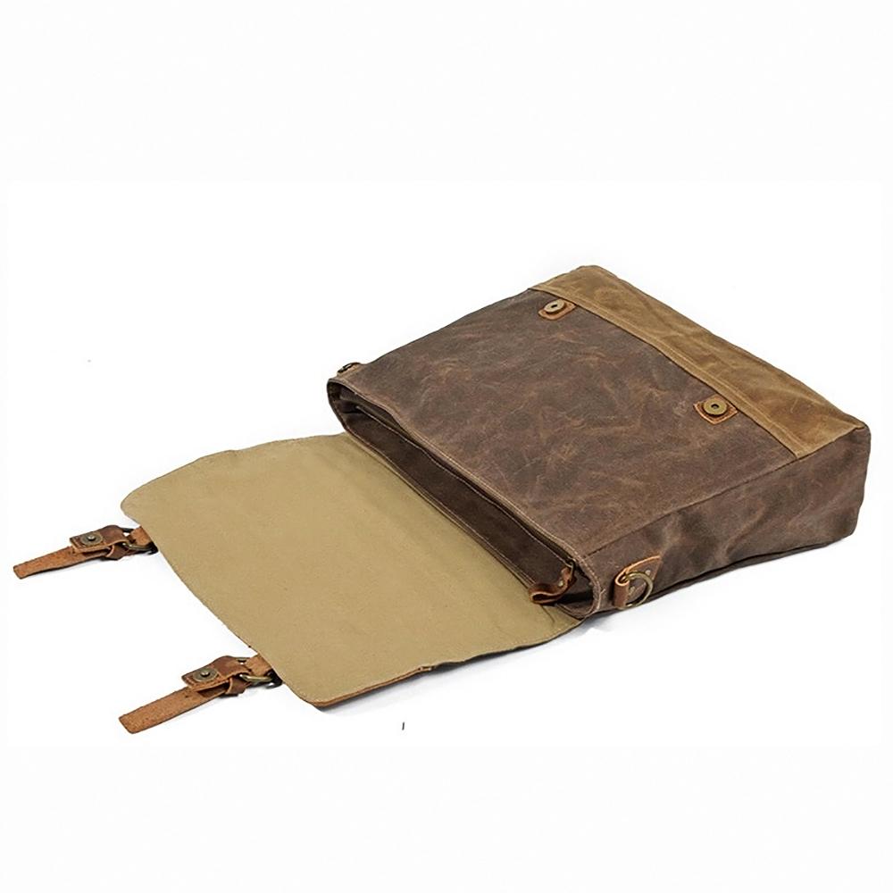 Messenger bag lying flat with the flap open and magnetic snaps visible