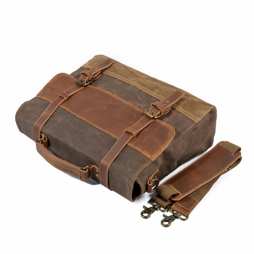 Bag resting on its back with the shoulder strap laid beside it