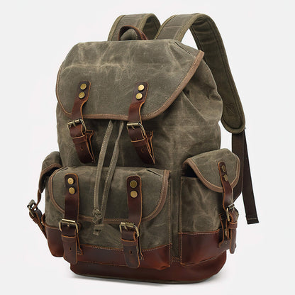 Army green vintage waxed canvas rucksack with brown leather trim, drawstring top and buckled pockets