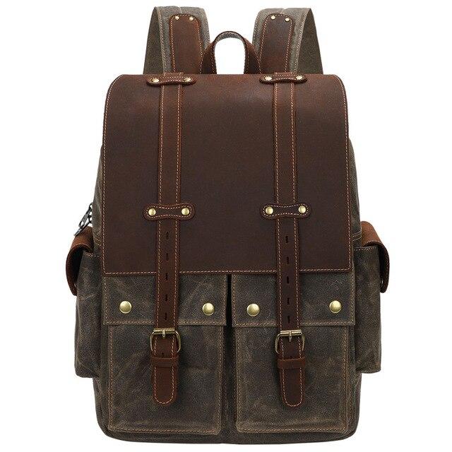 Army green waxed canvas camera backpack with a brown leather flap and straps