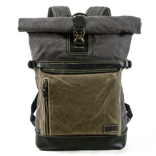 Army green waxed canvas roll top backpack with a contrasting front pocket and leather base