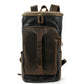 Black waxed canvas backpack with a rectangular leather front pocket