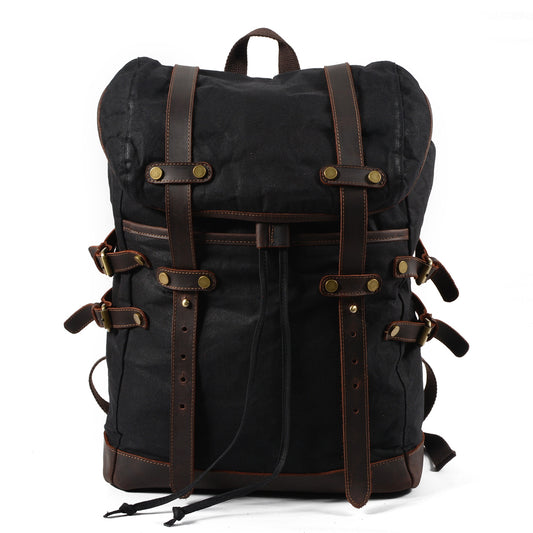 Black vintage waxed canvas laptop rucksack with crazy horse leather straps and brass buckles