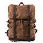 Brown vintage waxed canvas laptop rucksack with dark leather straps and buckles