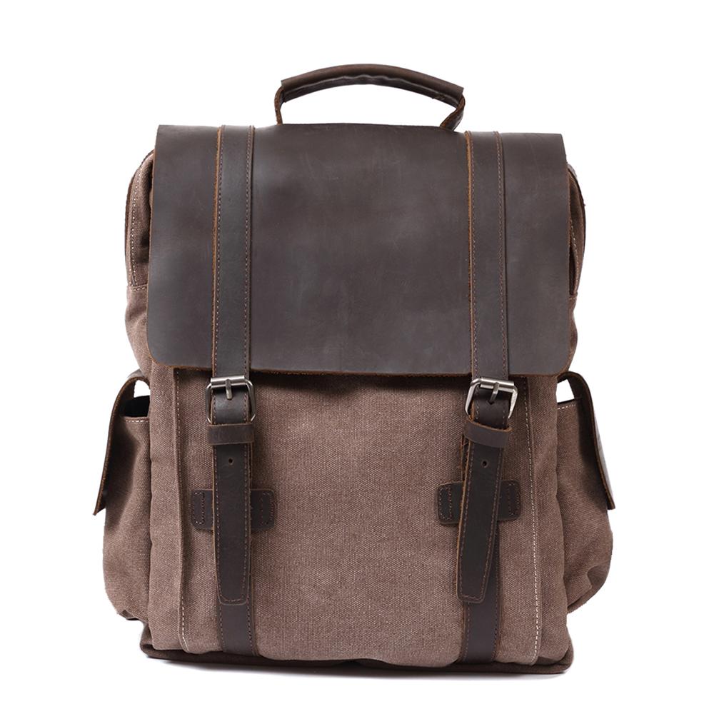 Front of coffee waxed canvas backpack with broad leather flap and twin buckle straps.