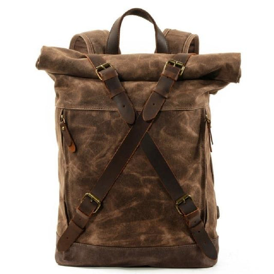 Coffee waxed canvas roll-top backpack with crossed leather straps, front view