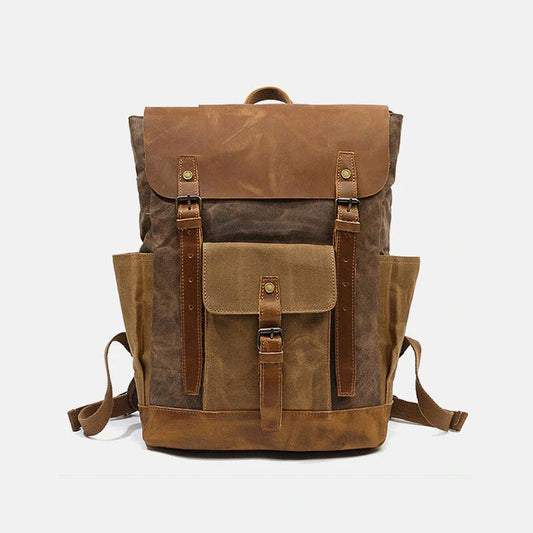 Coffee canvas and leather backpack with a leather flap, front pocket and twin buckle straps