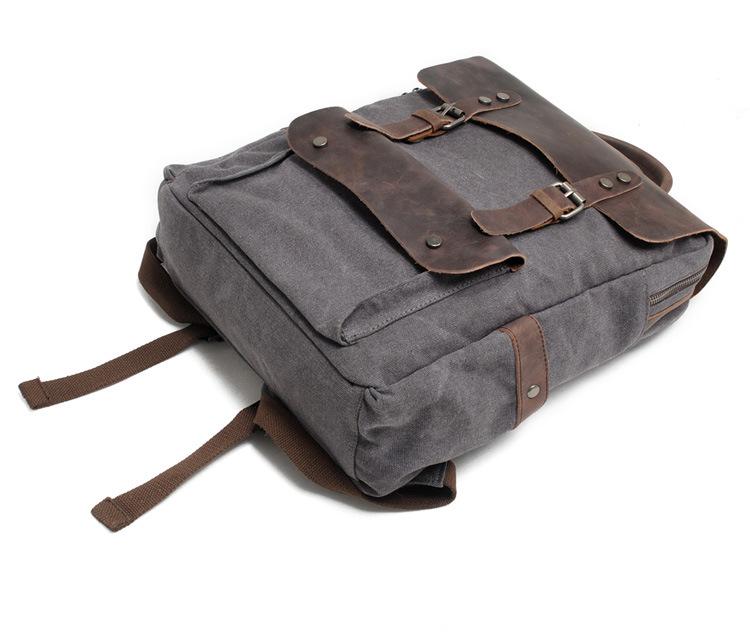 Dark Gray canvas backpack with the leather flap buckled and the front pocket visible.