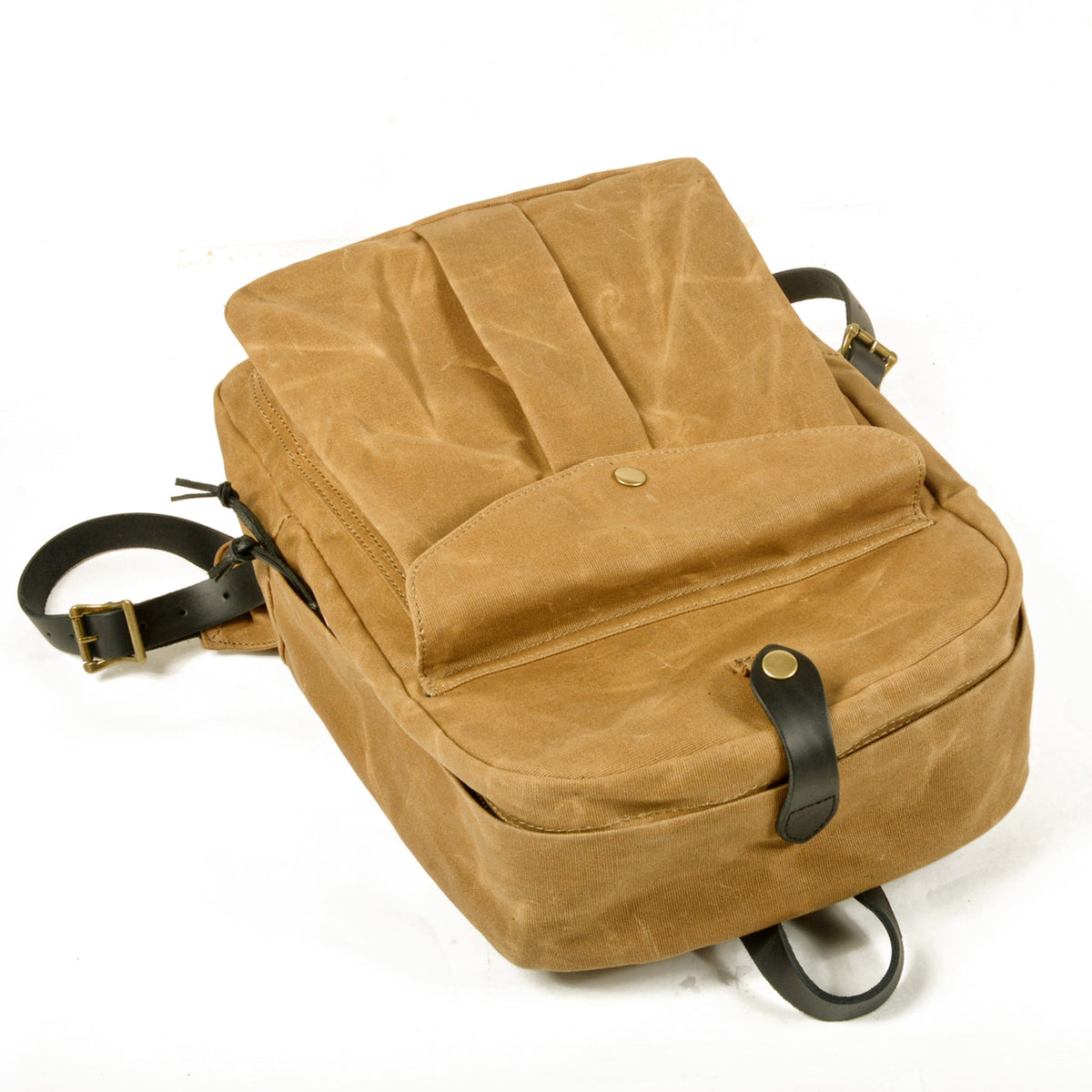 Khaki backpack lying flat with the snap front flap