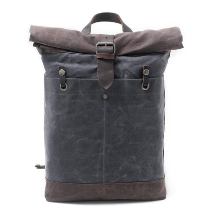 Gray water-resistant waxed canvas roll top backpack with a leather buckle strap