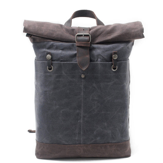 Gray water-resistant waxed canvas roll top backpack with a leather buckle strap