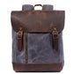 Gray water-resistant waxed canvas school backpack with a leather flap and base