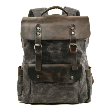 Gray waxed canvas laptop backpack with a crazy horse leather flap and buckle straps