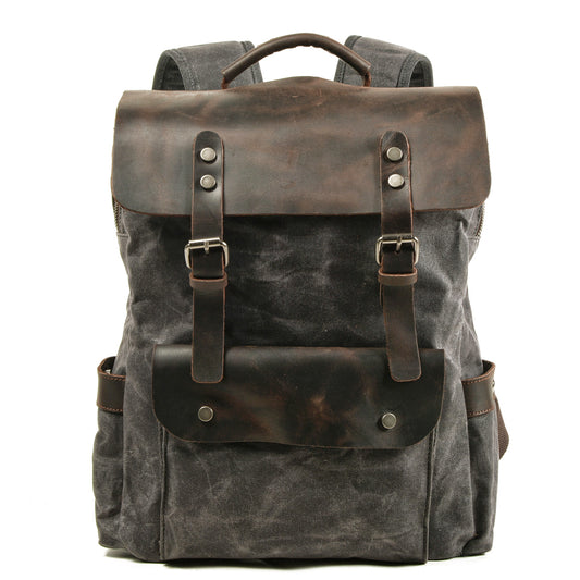 Gray waxed canvas laptop backpack with a crazy horse leather flap and buckle straps