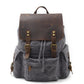 Gray waxed canvas laptop backpack with a brown leather flap and brass buckles