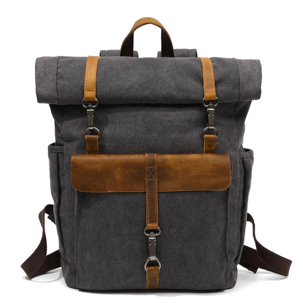 Gray waxed canvas roll top backpack with a crazy horse leather front flap
