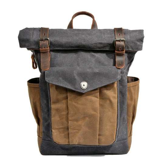 Gray waxed canvas roll top rucksack with a front pocket and leather straps
