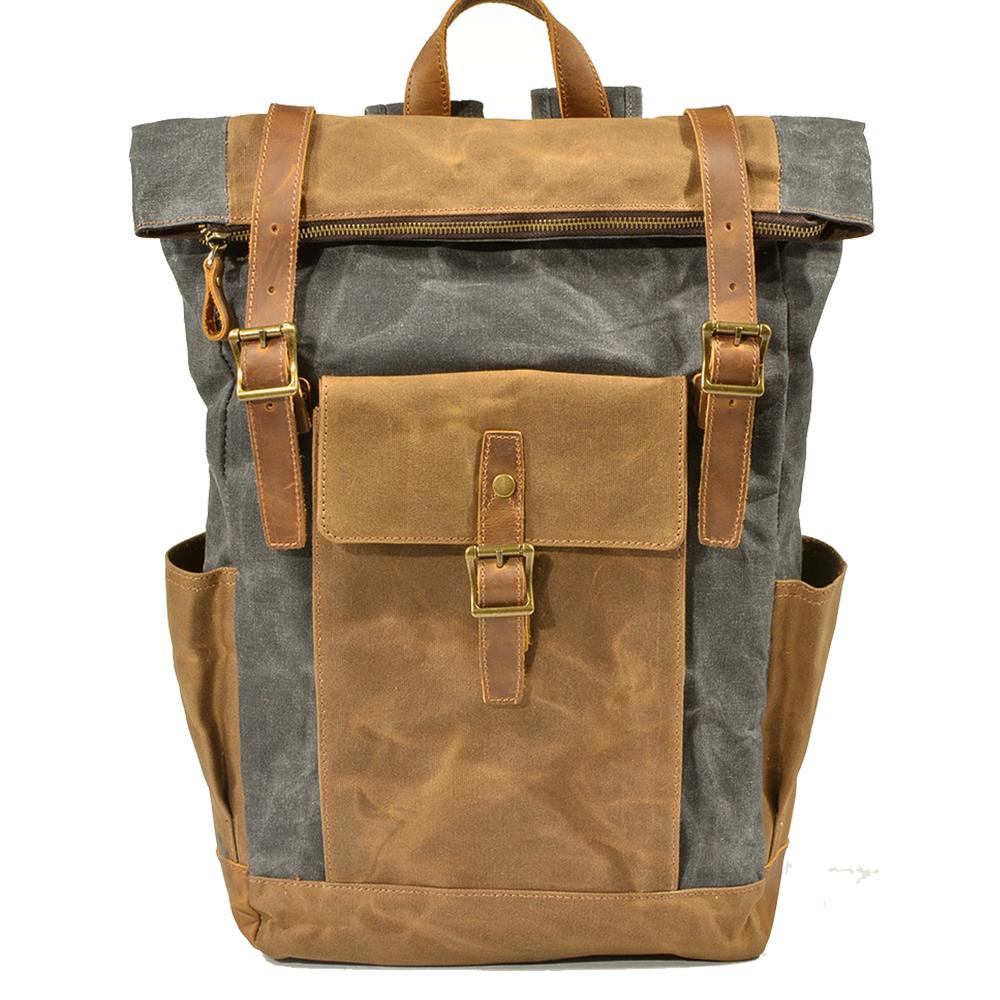 Gray roll top waxed canvas backpack with a leather front pocket