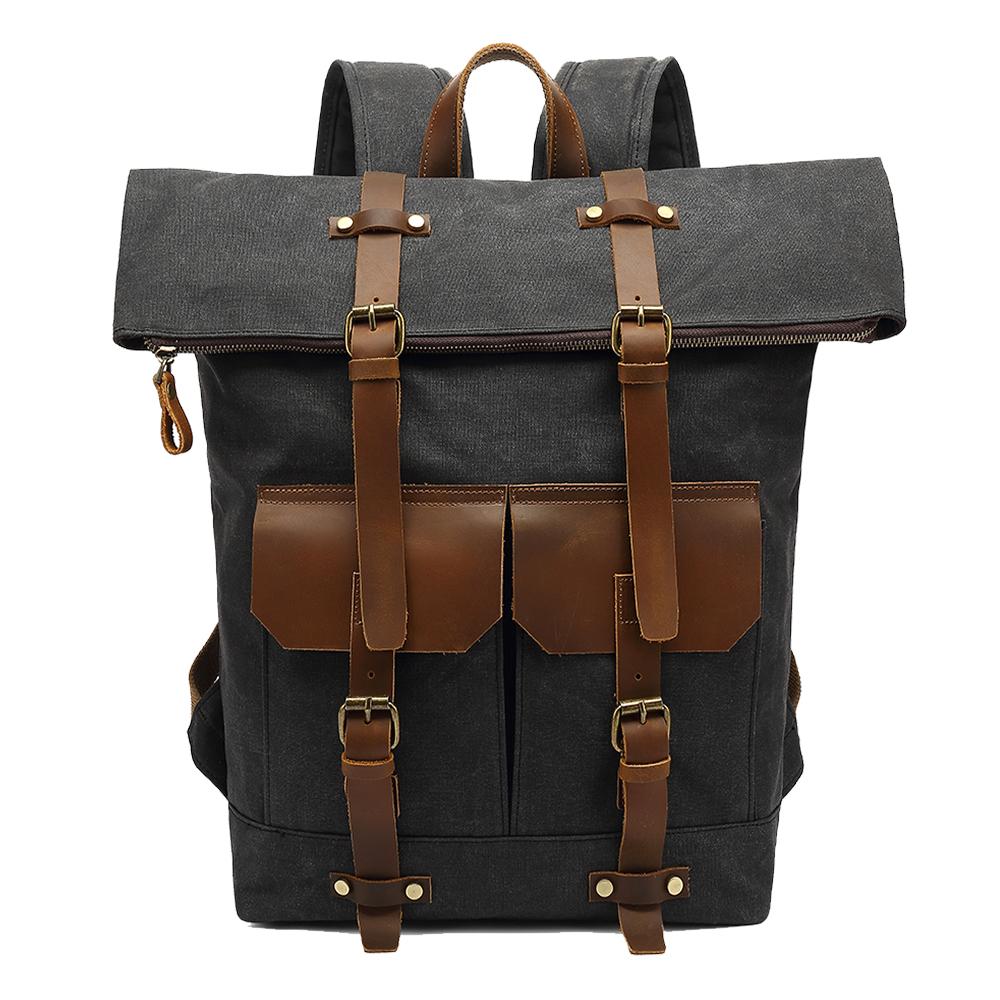 Gray waxed canvas roll top backpack with brown leather buckles and front pockets