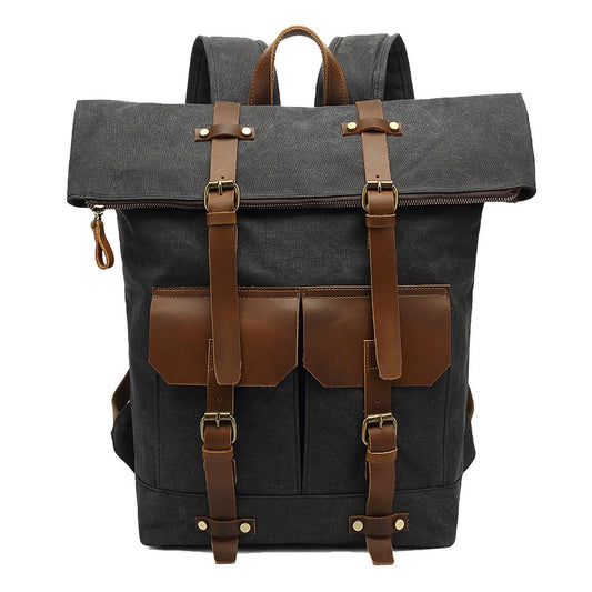 Gray waxed canvas roll top backpack with brown leather buckles and front pockets