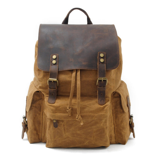 Khaki waxed canvas laptop backpack with a crazy horse leather flap and buckle straps