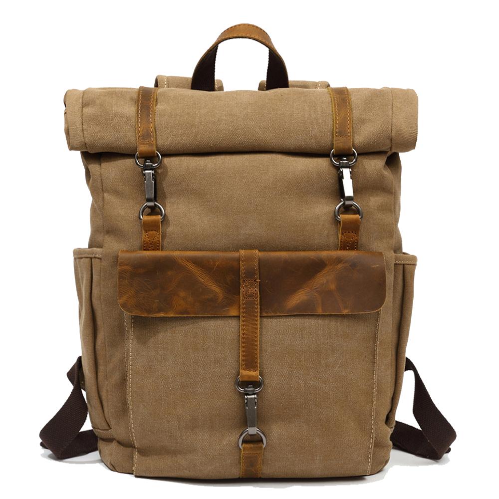 Khaki waxed canvas roll top backpack with a leather front flap and snap hooks
