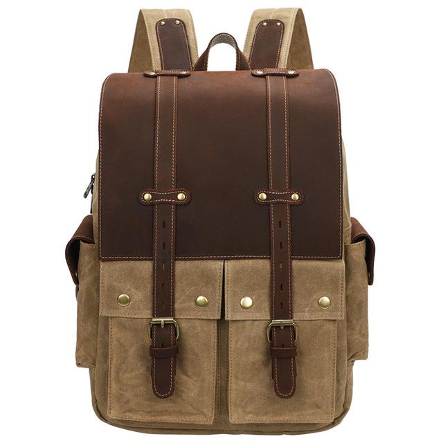 Khaki waxed canvas camera backpack with a brown leather flap and two buckled front pockets