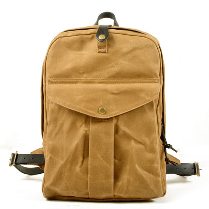 Khaki waxed vintage canvas school backpack with a snap front pocket and leather top handle