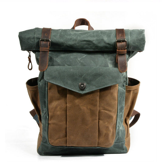 Lake green waxed canvas laptop roll top backpack with a brown leather buckle closure